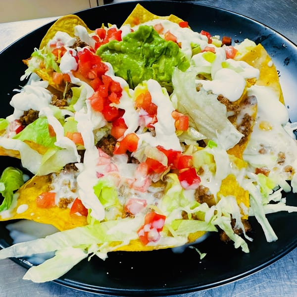 Coco Mexican Restaurant's nachos, loaded with ground beef, lettuce, tomatoes, sour cream, and guacamole.